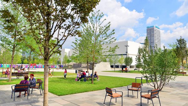 A park with seating, lawns and trees