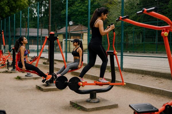 People working out on outdoor fitness equipment