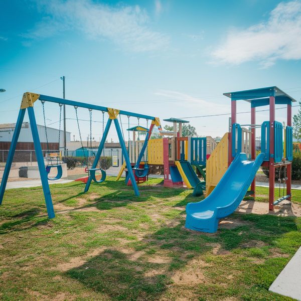 A playground with swings and a slide