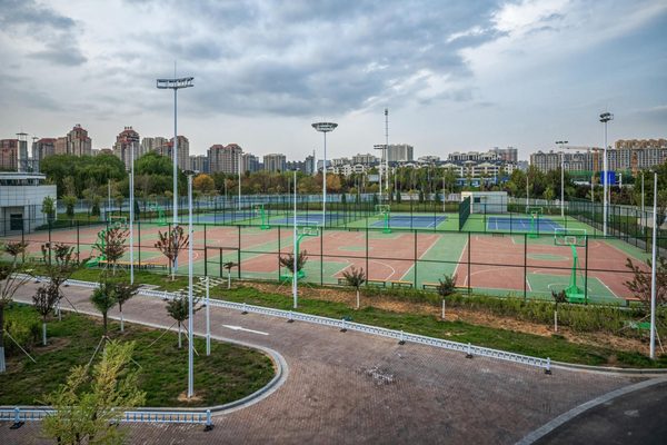 Sports courts seen from above, with floodlights