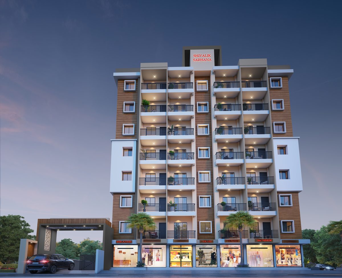 Shivalik Sadhana at dusk seen from the front: timber-clad and white residential floors with balconies above a row of lit shops, beside the entrance gate, architect's render