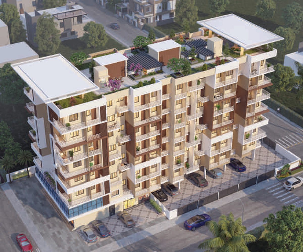 Shivalik Sankalp from above, showing its two linked wings, the planted roof and the paved parking court beside the building, architect's render