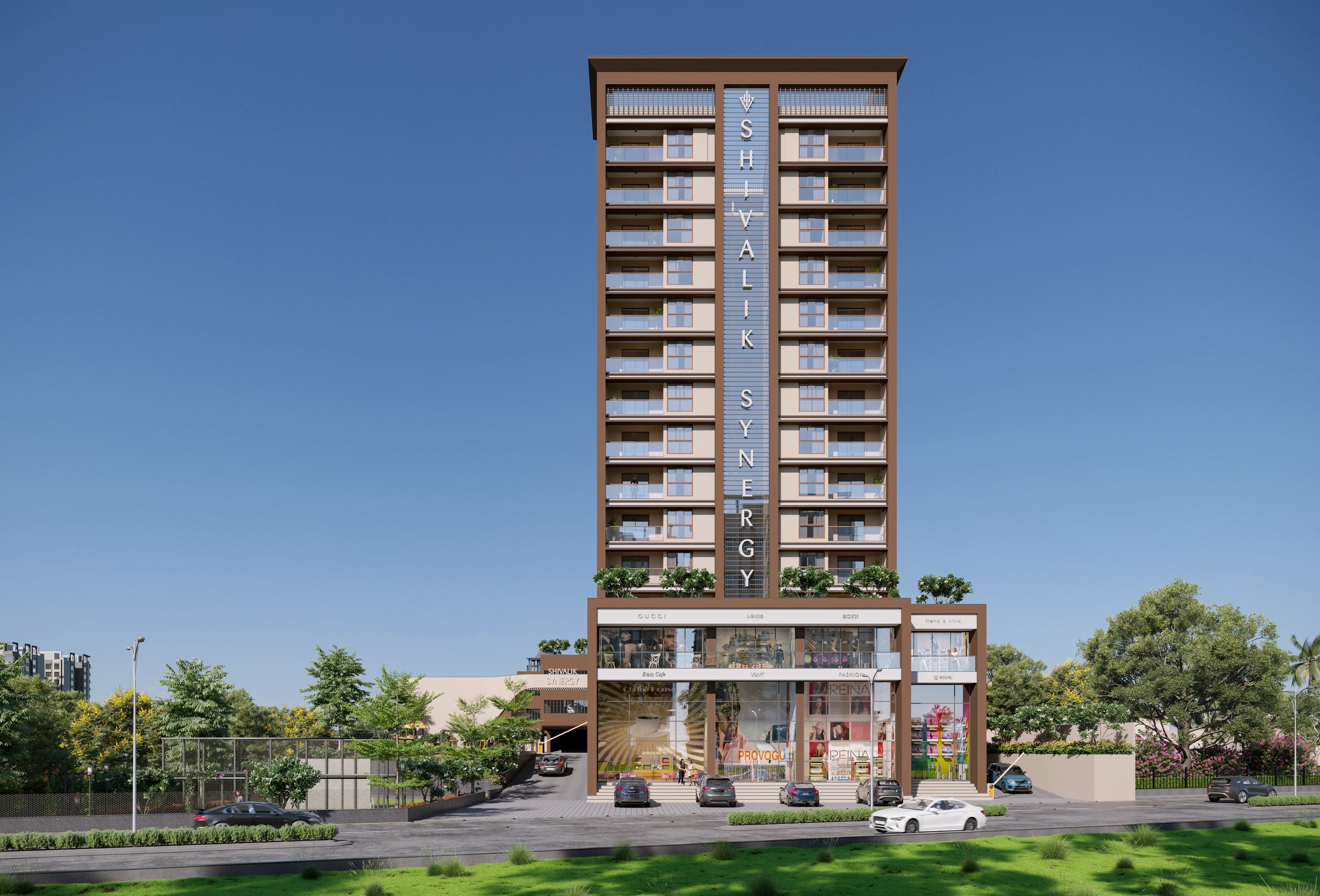 Shivalik Synergy seen from the front: a tall tower in terracotta and cream with the name down its centre, above shops and a green verge, architect's render